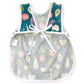 the back of a baby apron showing the ties, in a vegetable pattern