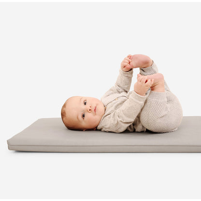baby laying on gathre padded mat in pewter