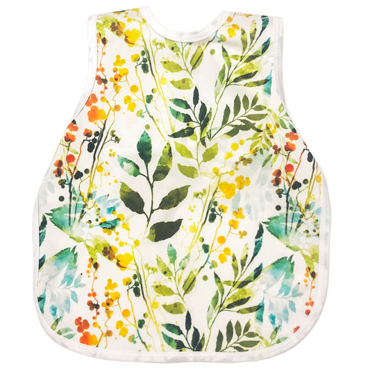 A bapron baby apron in a white with leaves pattern called 'autumn leaves'