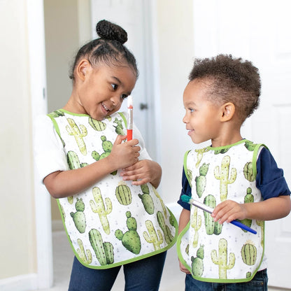 2 cute kids wearing bapron bibs with the cactus pattern